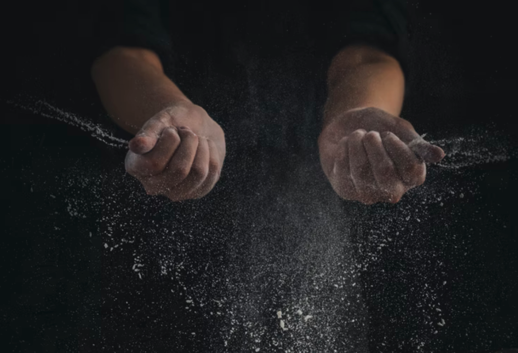 hands holding salt while cooking